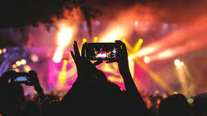 Group of friends enjoying a live music concert funded with Vizzve instant loan